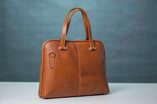 Free Brown Leather Handbag on White Table Stock Photo
