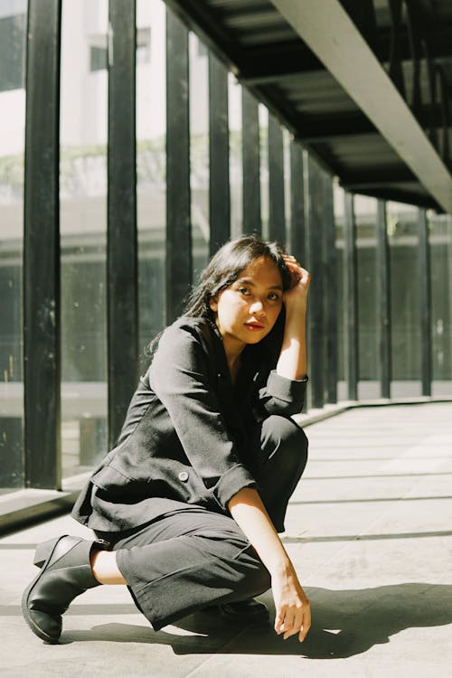 A Woman Wearing a Black Blazer and Black Pants