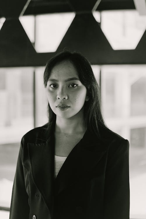 Young Woman with Black Long Hair in Building Interior