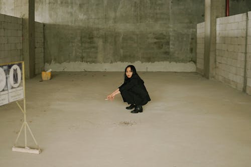 Woman in Black Suit Smoking a Cigarette