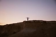 Person Standing on Top of a Mountain