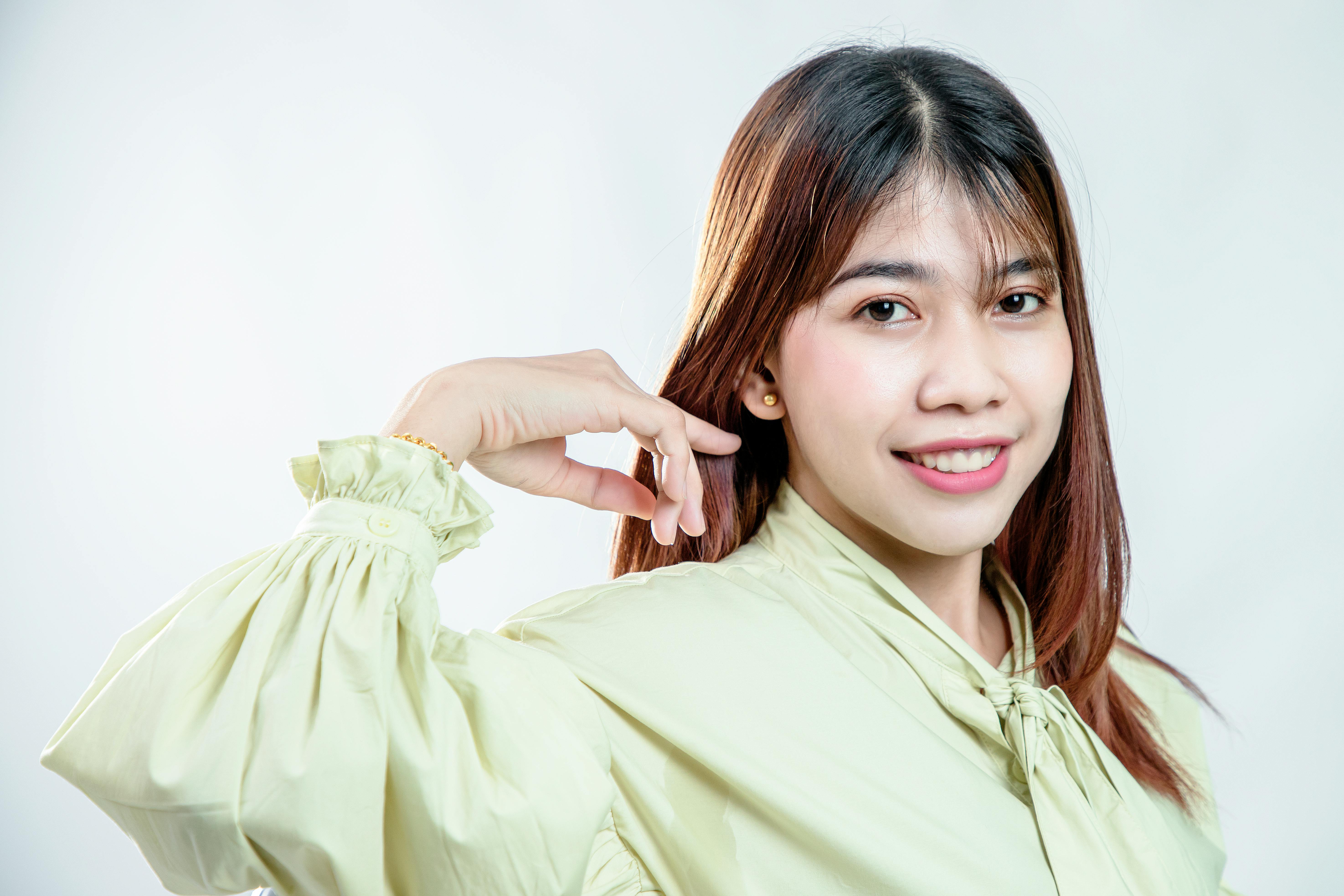 close up shot of a woman wearing green long sleeves