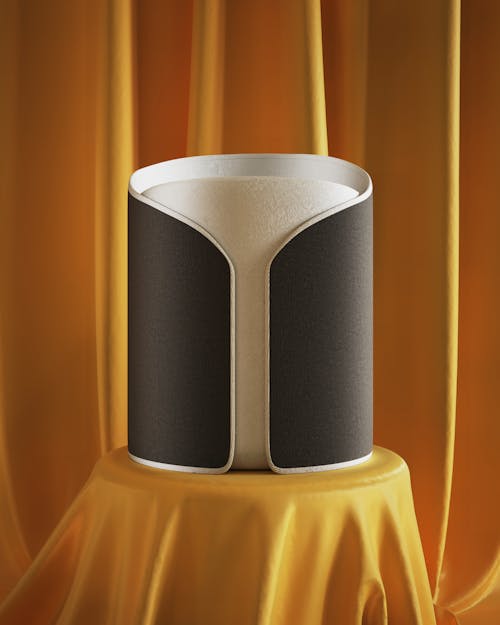 White Cylinder in Black Collar on Table