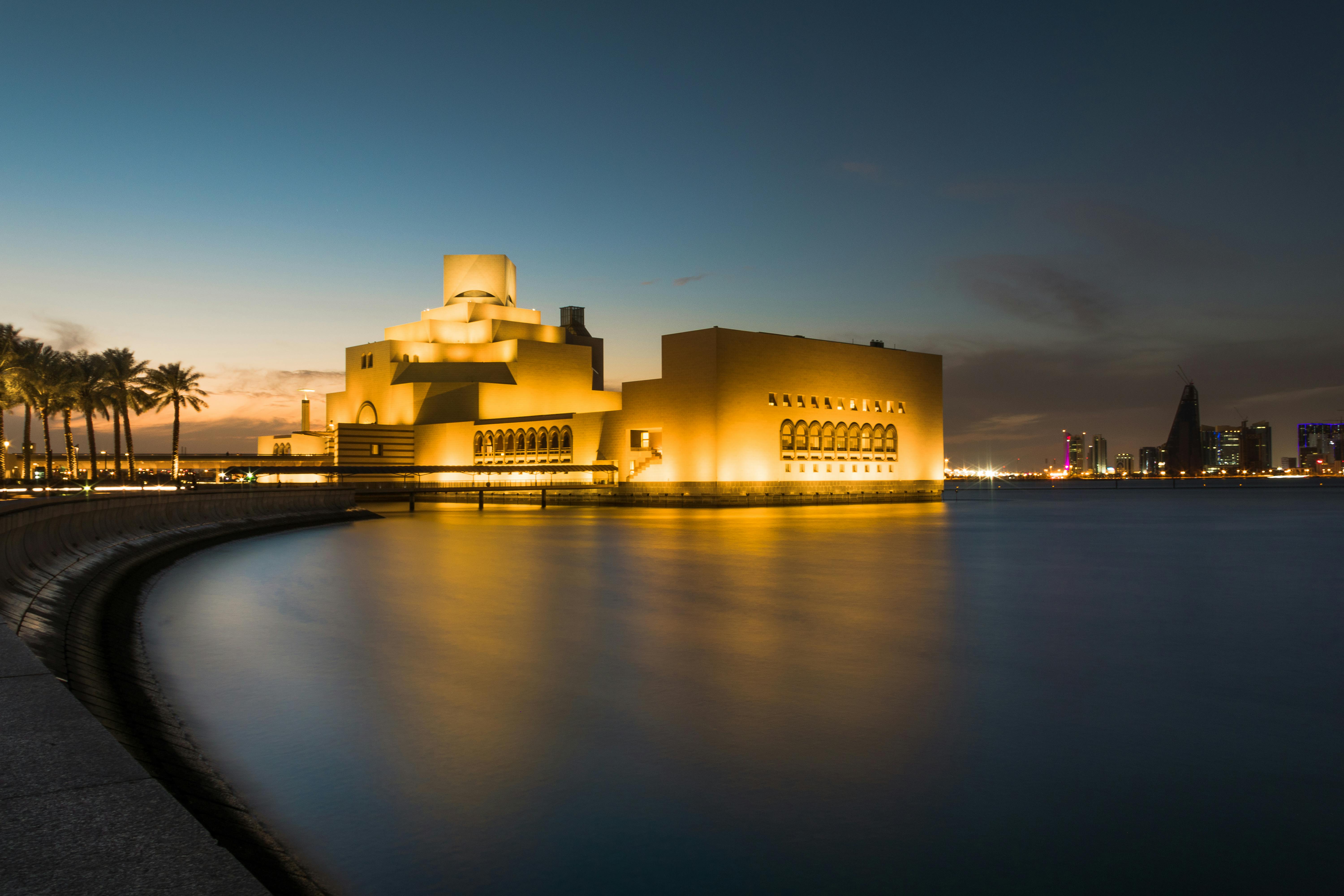Captivating night scene of the Museum of Islamic Art in Doha, Qatar, reflecting beautifully over cal