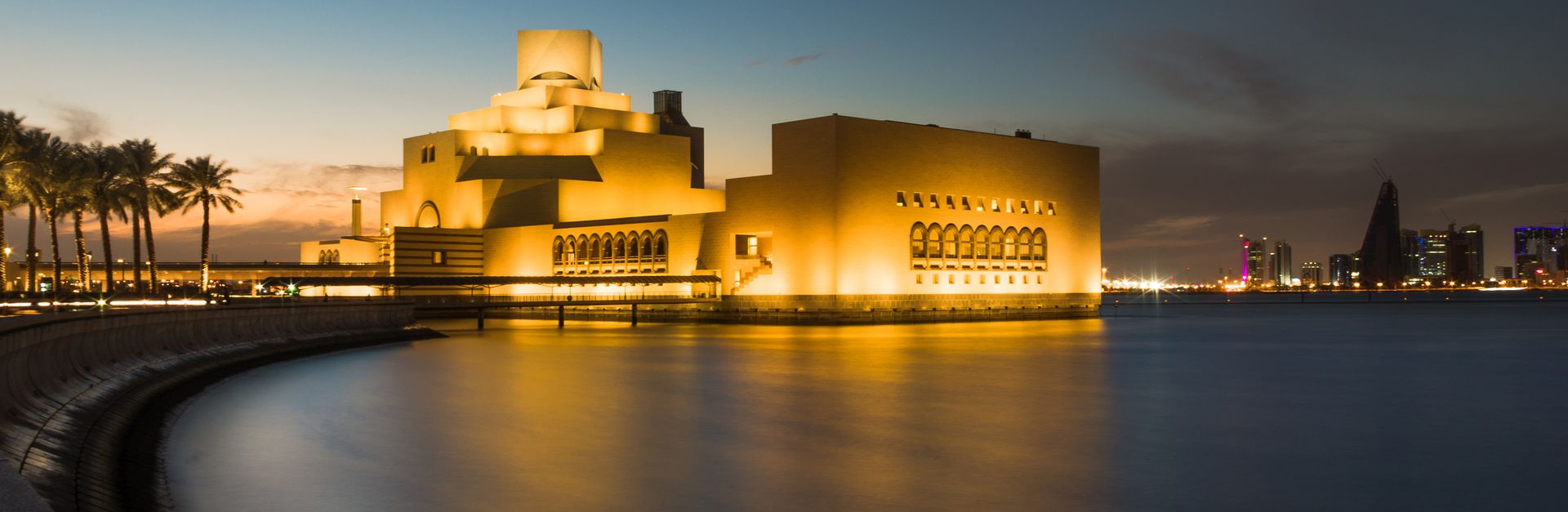 Captivating night scene of the Museum of Islamic Art in Doha, Qatar, reflecting beautifully over cal