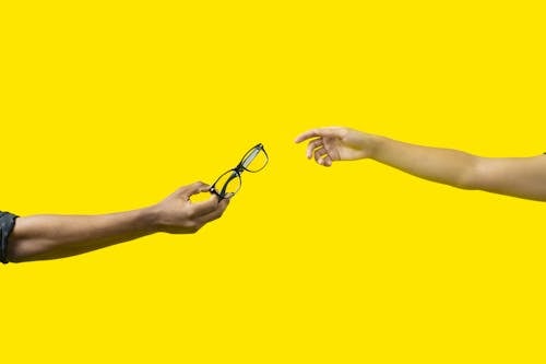 A Person Holding Black Framed Eyeglasses