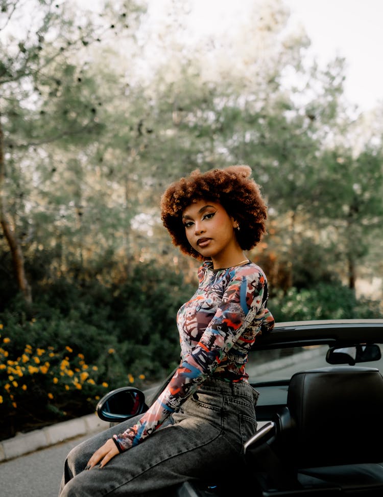 Attractive Woman With Red Coloured Curly Hair Sitting On Cabriolet