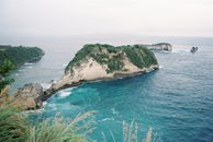 Green and Brown Island on Blue Sea Under White Sky