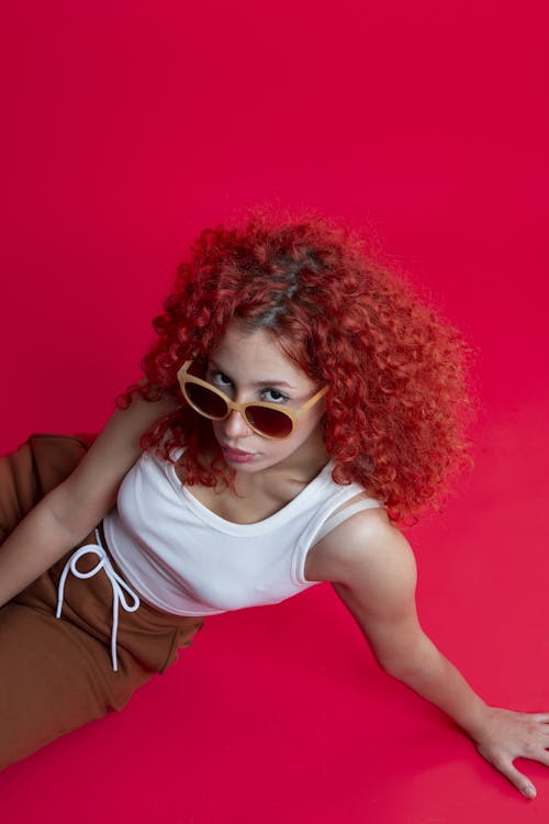 Woman in White Tank Top Wearing Sunglasses