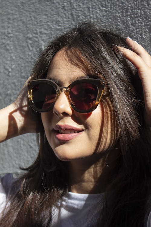 Close-Up Shot of a Woman with Sunglasses Smiling