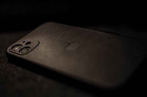 Free Detailed view highlighting a smartphone with a sleek black case, emphasizing elegance and modern design. Stock Photo