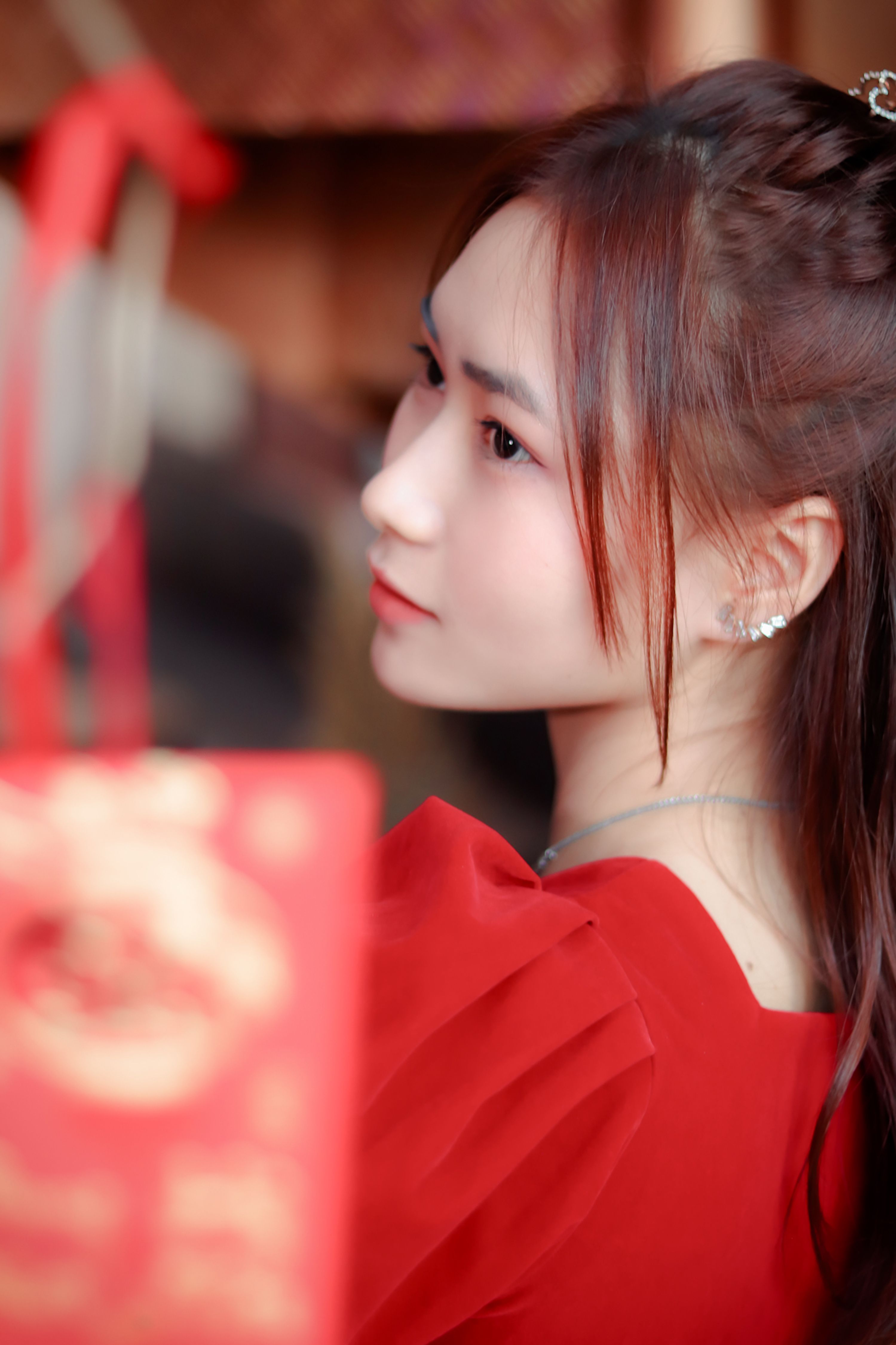 A beautiful portrait of an Asian woman in a red dress, capturing elegance and grace.