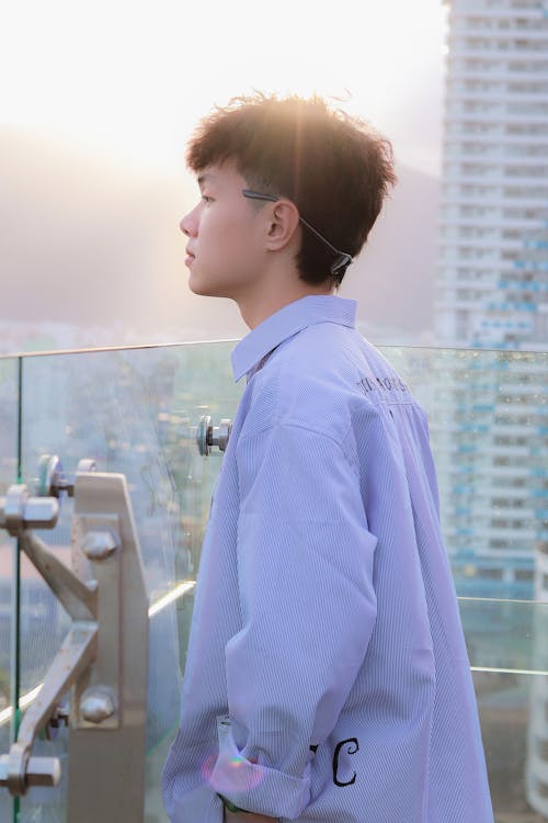 A Man Wearing a White Long Sleeved Shirt on a Rooftop