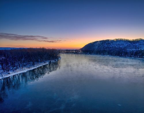 Free A serene winter dawn over the icy Mississippi River in Red Wing, Minnesota, USA. Stock Photo