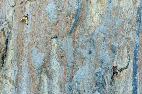 Free 2 Persons Climbing a Rocky Mountain Stock Photo