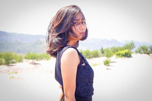 Woman in Blue Sleeveless Dress Standing on the Hill Dday