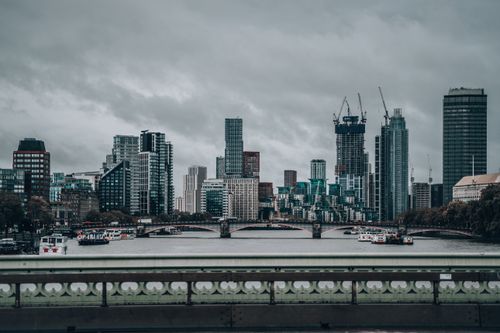 Free Iconic London skyline featuring modern architecture beneath a dramatic cloudy sky. Stock Photo