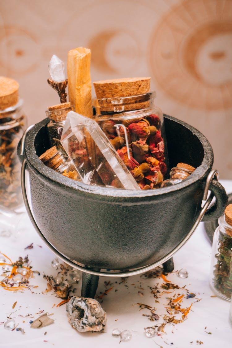 Cauldron With Dry Spices In Glass Jars 