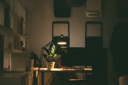 A Lit Lamp on a Computer Desk