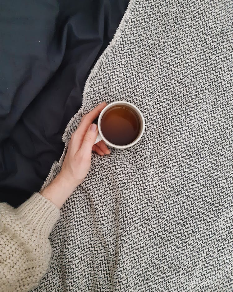 Hand Holding Cup Of Tea