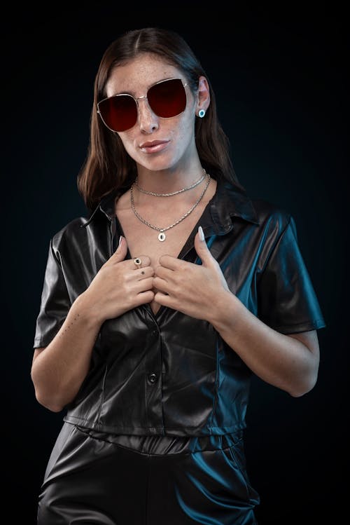 A Woman in Black Leather  Shirt Wearing Sunglasses