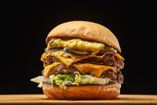 Juicy cheeseburger with pickles, lettuce, and sauce, perfect for food enthusiasts.