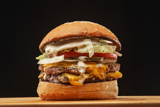 Close-up of a delicious double cheeseburger with toppings, perfect for fast food lovers.