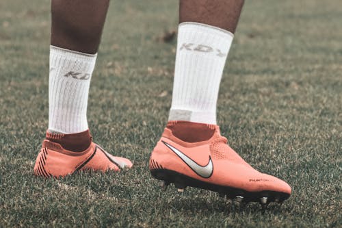 Free A Person Wearing Cleats on a Field Stock Photo