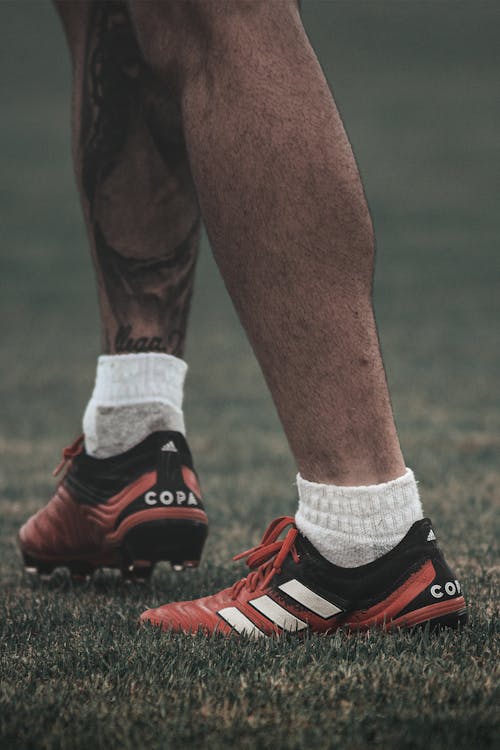 Free Close-Up Shot of a Person Wearing Adidas Shoes Stock Photo