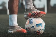 A Player Stepping on a Soccer Ball