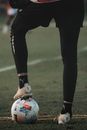 Person in Black Pants and White and Blue Soccer Ball