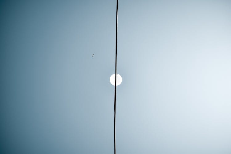 Abstract Image Of A Sky With Moon And Electric Wire