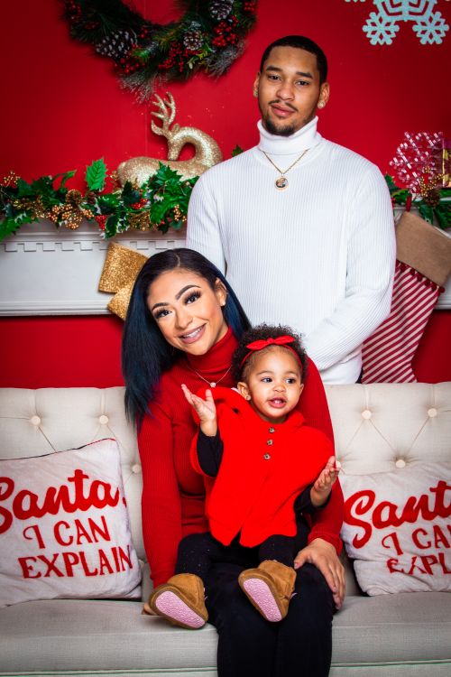 Free African American family enjoying holiday season indoors with festive decorations. Stock Photo