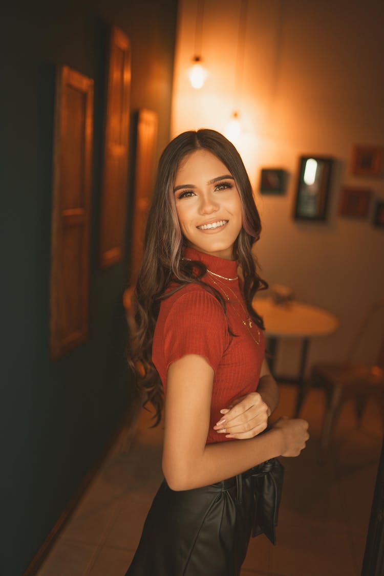 A Portrait Of A Woman In A Red Turtleneck Top