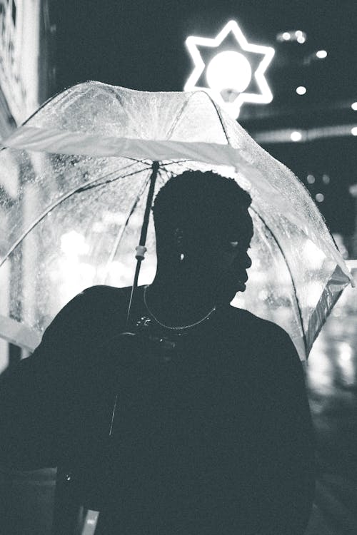 Free Grayscale Photo of a Person Holding an Umbrella Stock Photo