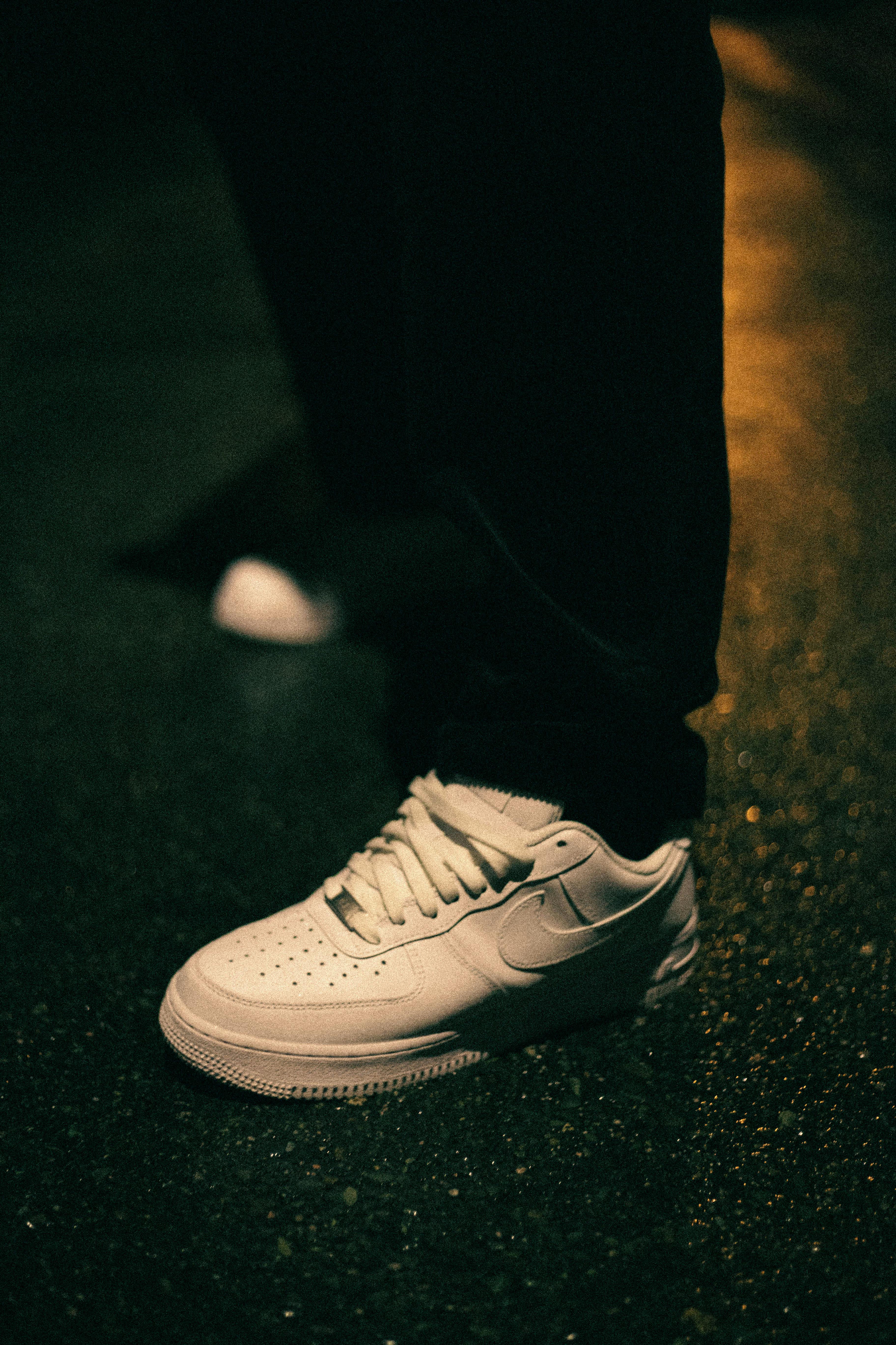 close up photo of a person wearing white shoe