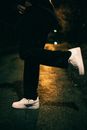 A Person in Black Pants and White Nike Sneakers