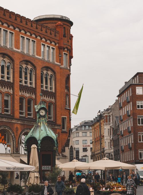 Free Lively market square in Copenhagen with historic architecture and a vibrant atmosphere. Stock Photo