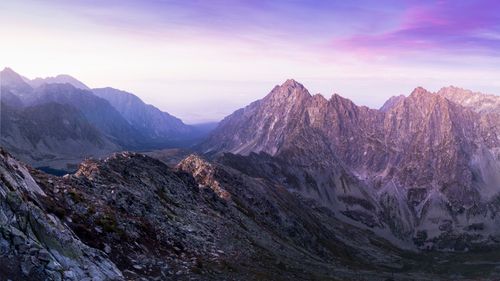 Free Stunning view of a rocky mountain range during sunrise with a colorful sky. Stock Photo