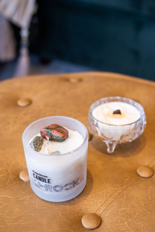 Free Elegant candles with gemstones on a leather surface, ideal for modern interior design. Stock Photo