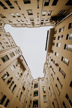 Looking up at symmetrical residential buildings forming a courtyard.
