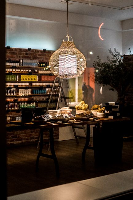Charming shop interior with elegant pendant lamp and rustic decor in Munich, Germany.