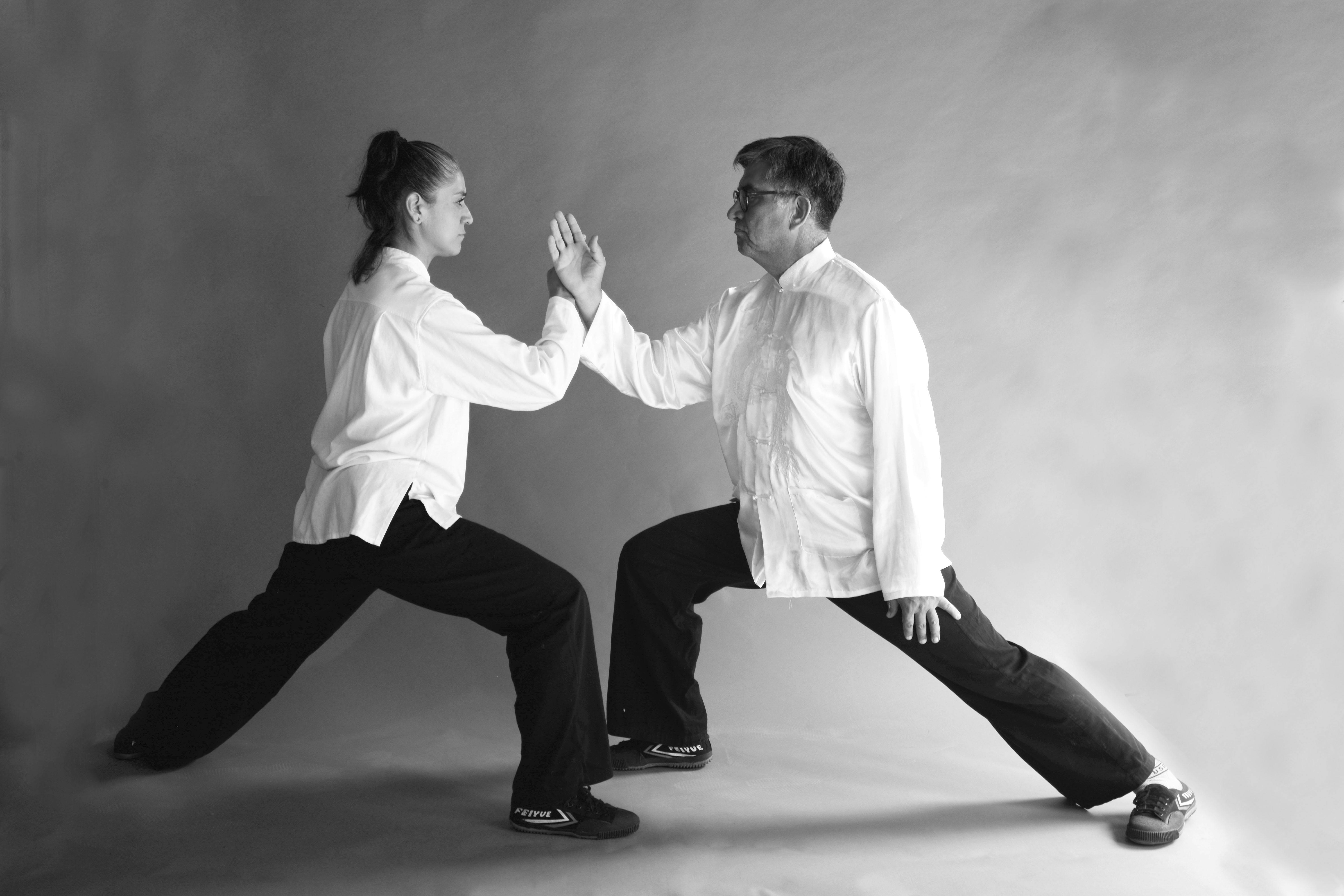 man and woman posing in karate positions