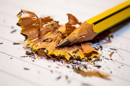 Free Yellow Black Pencil Sharpened Above the White Paper in Macro Photography Stock Photo