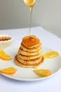 Pancakes With Sliced Lemon on White Ceramic Plate