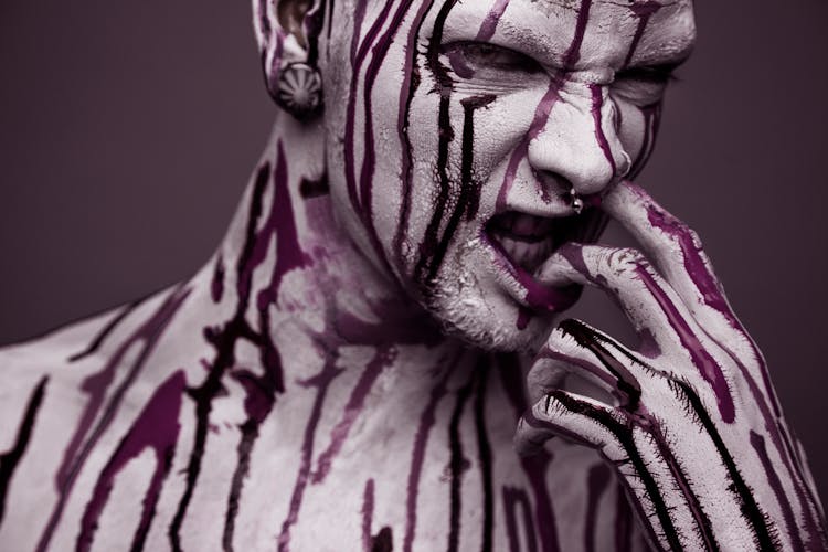 A Model Covered With Paint Looking Fierce