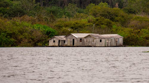 Free Worn Out Wooden Houses Near a Body of Water Stock Photo