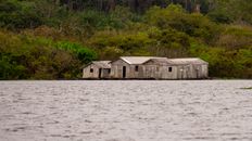 Worn Out Wooden Houses Near a Body of Water