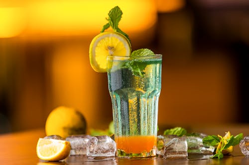 Free Selective Focus of a Cocktail Drink with Sliced Lemon on Wooden Surface Stock Photo