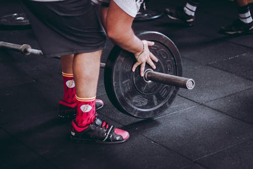 Free Person Holding Black Weight Plate Stock Photo